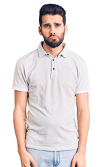 Young handsome man with beard wearing casual polo depressed and worry for distress, crying angry and afraid. sad expression.