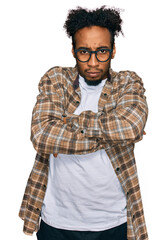 Young african american man with beard wearing casual clothes and glasses skeptic and nervous, disapproving expression on face with crossed arms. negative person.