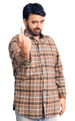 Young hispanic man wearing casual clothes showing middle finger, impolite and rude fuck off...