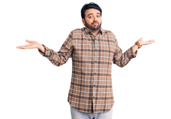Young hispanic man wearing casual clothes clueless and confused expression with arms and hands raised. doubt concept.