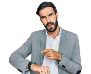 Young hispanic man wearing business clothes in hurry pointing to watch time, impatience, upset and angry for deadline delay