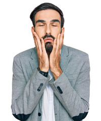 Young hispanic man wearing business clothes tired hands covering face, depression and sadness, upset and irritated for problem