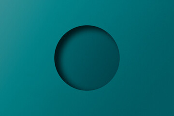 Green paper cut into circular holes stacked with light and shadow.