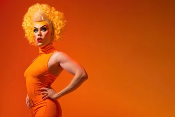 Fotobehang Drag queen posing over orange background studio shot with copy space for advertisement or text. Generative AI © Pajaros Volando