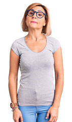 Fototapeta premium Young blonde woman wearing casual clothes relaxed with serious expression on face. simple and natural looking at the camera.