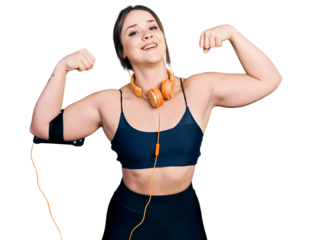 Young hispanic girl wearing sportswear doing strong gesture smiling and laughing hard out loud because funny crazy joke.