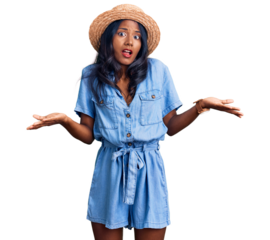 Young indian girl wearing summer hat clueless and confused with open arms, no idea concept.
