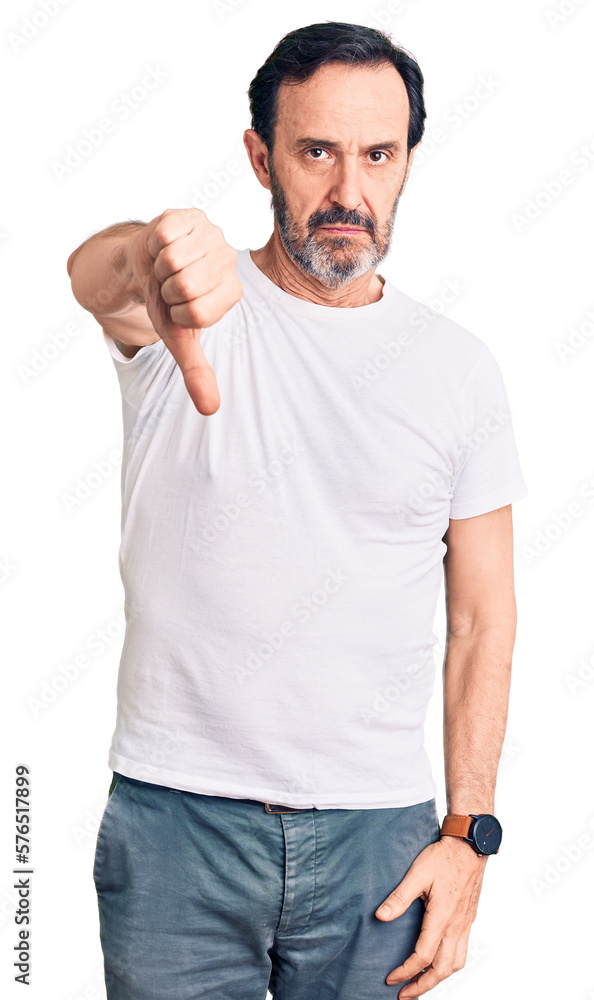 Sticker Middle age handsome man wearing casual t-shirt looking unhappy and angry showing rejection and negative with thumbs down gesture. bad expression.