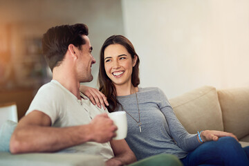Happy hearts make happy homes. Shot of a happy young couple relaxing together at home.