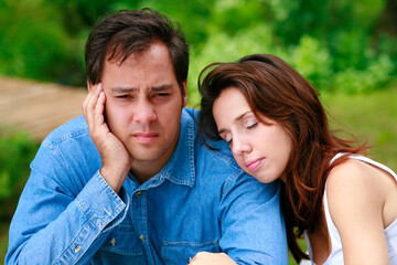 Close up outdoor portrait of affectionate couple showing despair.