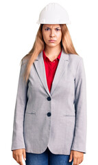 Beautiful young woman wearing architect hardhat skeptic and nervous, frowning upset because of problem. negative person.