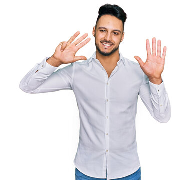 Young arab man wearing casual clothes showing and pointing up with fingers number nine while smiling confident and happy.