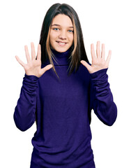 Young brunette girl with long hair wearing turtleneck sweater showing and pointing up with fingers...