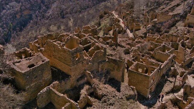 Old stone houses in abandoned mountain village. Aerial view of ancient city in Dagestan.