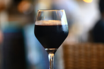 a glass of red wine in a luxurious background restaurant