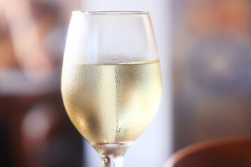 white wine tasting, chilled ice wine in a cold glass in summer