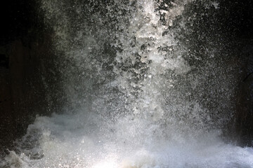 jet stream of water in a waterfall detal abstract background