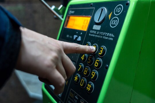 公衆電話をかける人(夜)