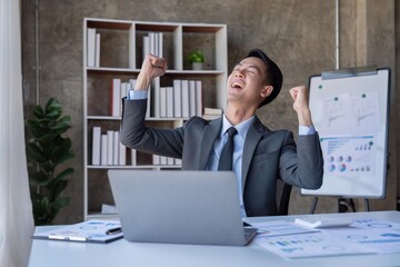 Naklejka premium Marketing, Financial, Accounting, and Planning, a businessman expresses his joy at making annual profits for a successful company