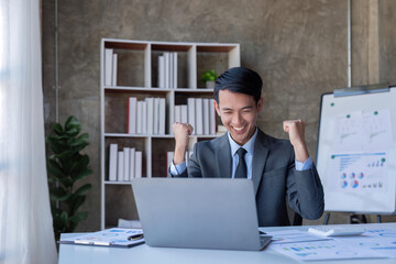 Naklejka premium Marketing, Financial, Accounting, and Planning, a businessman expresses his joy at making annual profits for a successful company
