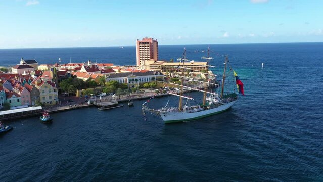 The flagship Gloria of the Colombian Navy entering the port of Willemstad escorted by port tugs. Cura&ccedil;ao Island.Netherlands Antilles. July 30, 2022.