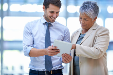 Thats quite impressive. A cropped shot of two colleagues discussing work on a tablet.