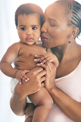 Black woman with baby, love and hug with family, content and bonding with face and early childhood and happiness. African female, mother holding child with parenting, motherhood and cuddle with care