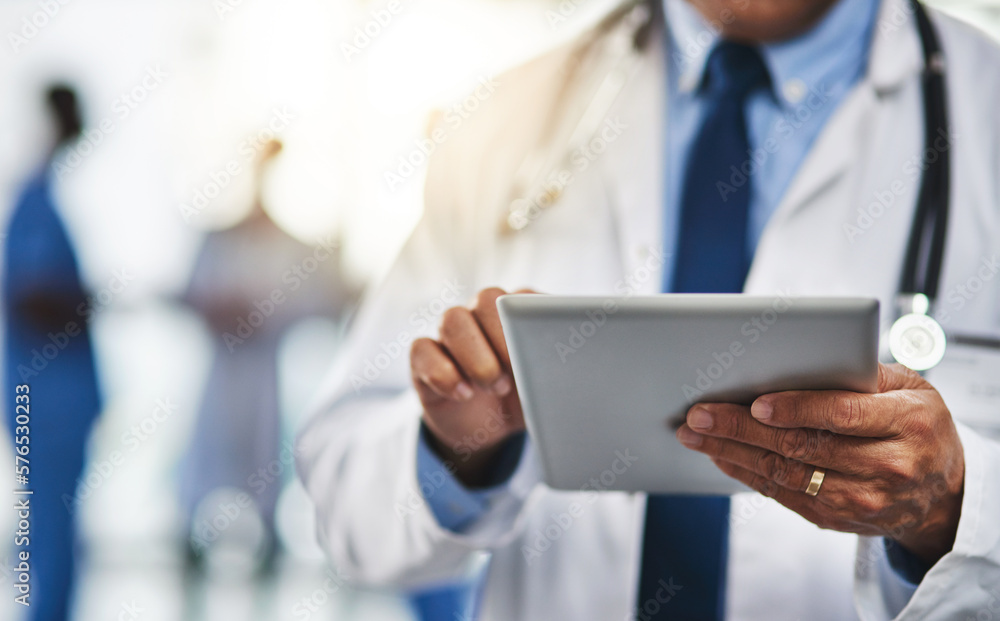 Poster keeping his patients file close to him with wireless technology. cropped shot of a doctor using a di