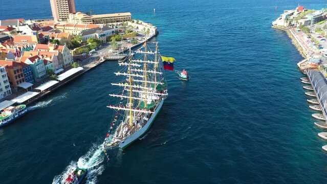 Pilot boat helping the flagship Gloria of the Colombian navy to dock in the port of Willemstad. Cura&ccedil;ao Island.Netherlands Antilles. July 30, 2022