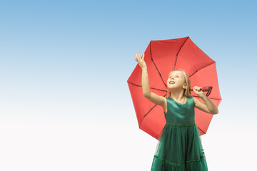 Cute little girl with umbrella on blue sky background. cute thoughtful child girl. dreaming people. space for text.
