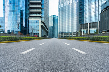 clean road through modern buildings in the city.