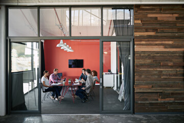 Making success happen. Shot of a group of colleagues having a meeting in a boardroom.