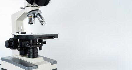 Black metal optical microscope with petri dish side view isolated on background