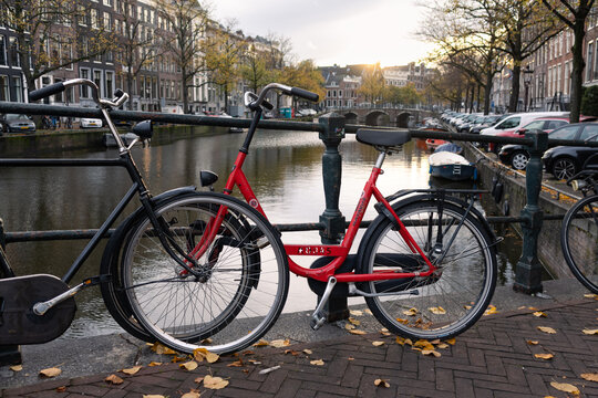 Red Bike on a Bridge along a Canal in the Grachtengordel Neighborhood during Autumn on October 17, 2022 in Amsterdam, Netherlands