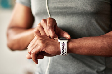 Exercise is more rewarding when you see your numbers in black and white. Cropped shot of an unrecognizable man checking his wristwatch.