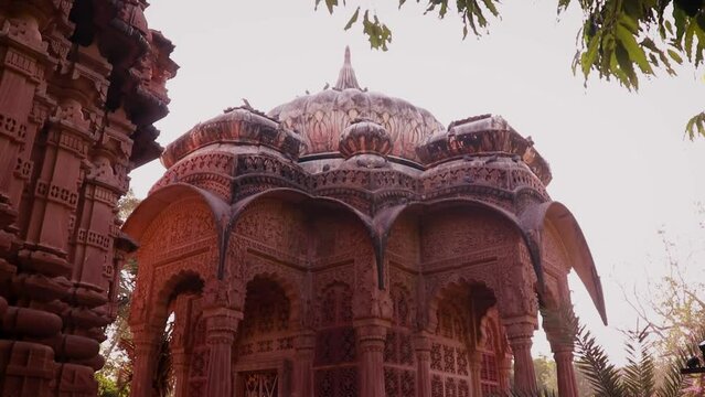 ancient hindu temple architecture with bright blue sky from unique angle at day shot taken at mandore garden jodhpur rajasthan india.