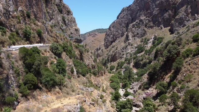 Aerial view through Topolia gorge, canyon road and lush mountain valley, Crete, Greece