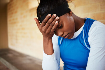 stress, headache and black woman with anxiety during fitness, routine or training against a brick wall background. Athletic, audition and girl with mental health issue, nervous and worried at stadium - obrazy, fototapety, plakaty