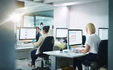 Success is the product of teamwork. Shot of corporate colleagues working together in their office.