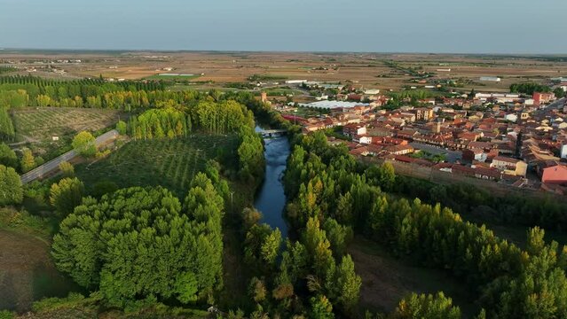 Flying over the Rio Esla river of Mansilla De Las Mules, Leon, Spain at sunset