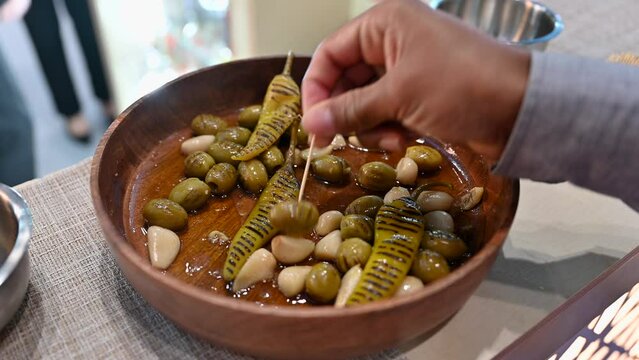 Closeup of grilled green olive, Garlic and Green Chilli pickles are displayed during the Gulf Food 2023