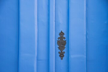 Old lock from the colonial period. Wooden door with blue paint. Space for text. Paraty, Brazil.