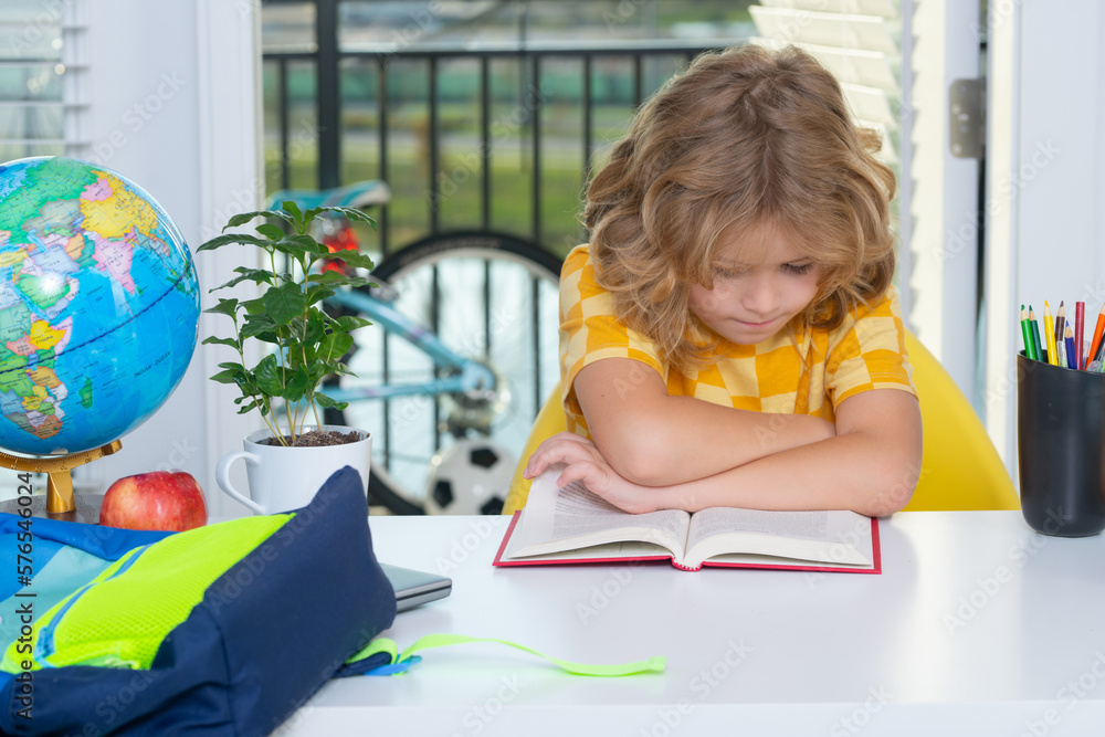 Fototapete Nerd pupil doing homework writing and reading at home. Child reading book. Clever child from elementary school with book. Smart genius intelligence kid ready to learn.