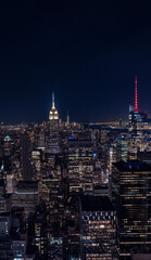 Fototapeta premium Tall Picture of the Manhattan Skyscrappers at Night