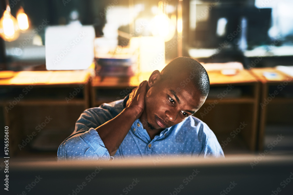 Sticker When its midnight and youre trying to make that deadline. Cropped shot of a handsome young businessman experiencing tension while using a computer late at work.