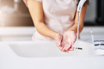 Practice good hygiene. Closeup shot of an unrecognizable woman washing her hands.