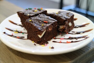 Fototapeta na wymiar Three dark chocolate brick cakes on a plate