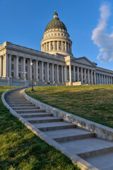 Utah State Capitol Hill - A vertical and wide-angle view of a steep concrete staircase winding up towards Utah State Capitol Building towering at top of the hill. Salt Lake City, Utah, USA.