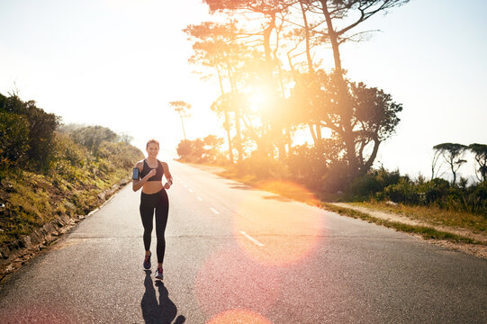 Get Running For A Full Body Burn. Shot Of A Fit Young Woman Going For A Run Outdoors.