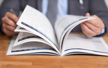 Keeping informed is the key to success. Cropped shot of an unidentifiable man reading a book.